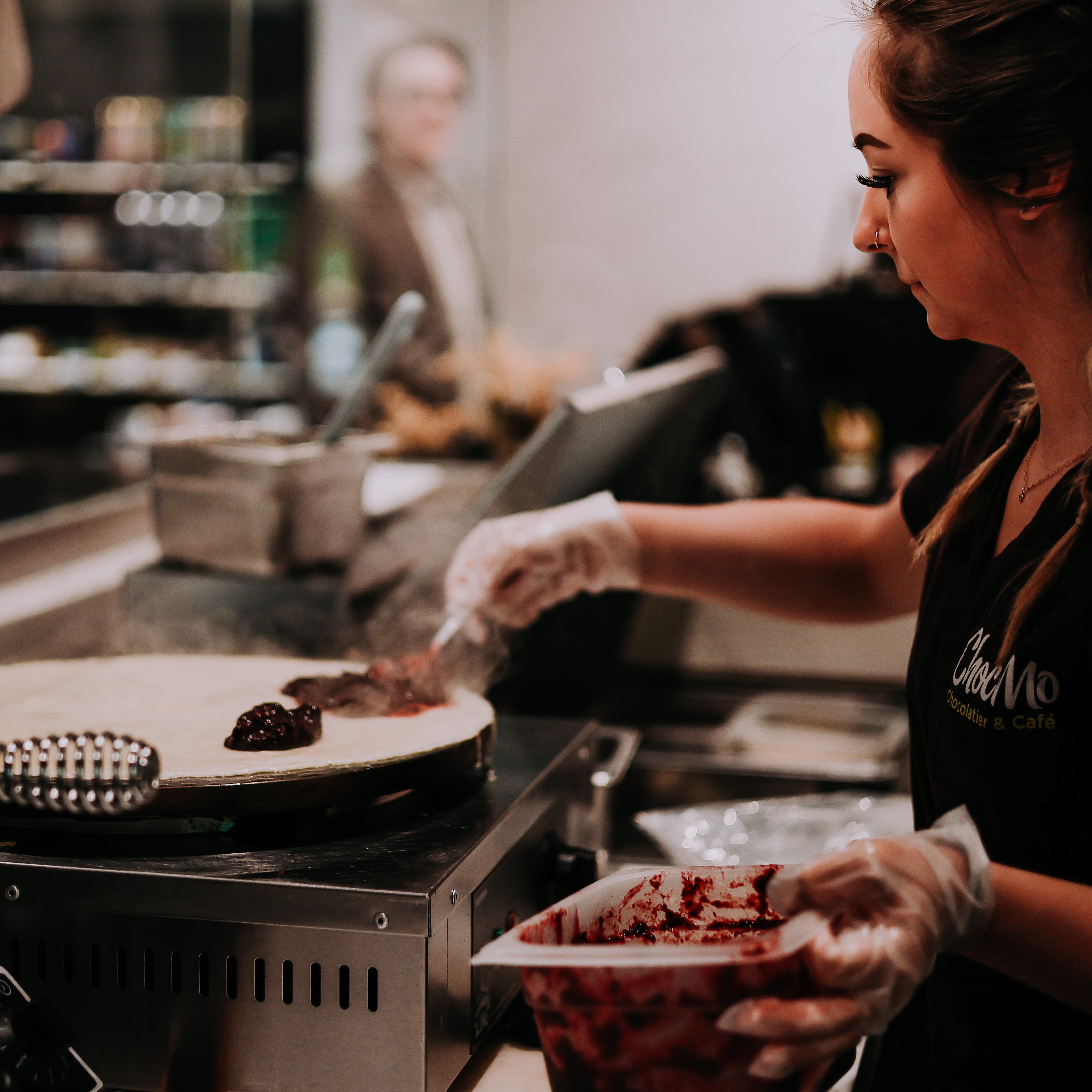 Person preparing food in a kitchen setting with a focus on the cooking process.